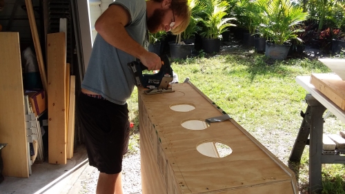 Joe cutting out the arm holes.