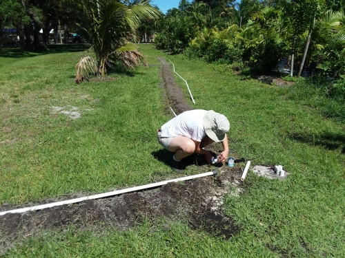 Gluing together PVC pipe sprinkler lines..