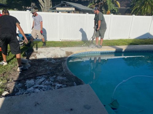 Jackhammering out the old pool deck.