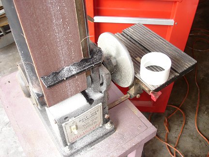 Sanding down the coupler to fit the cup-holder.